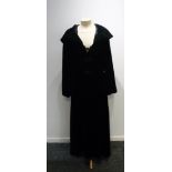 A VINTAGE BLACK VELVET LONG EVENING COAT WITH HOOD, the hood lined in dark green velvet with knotted