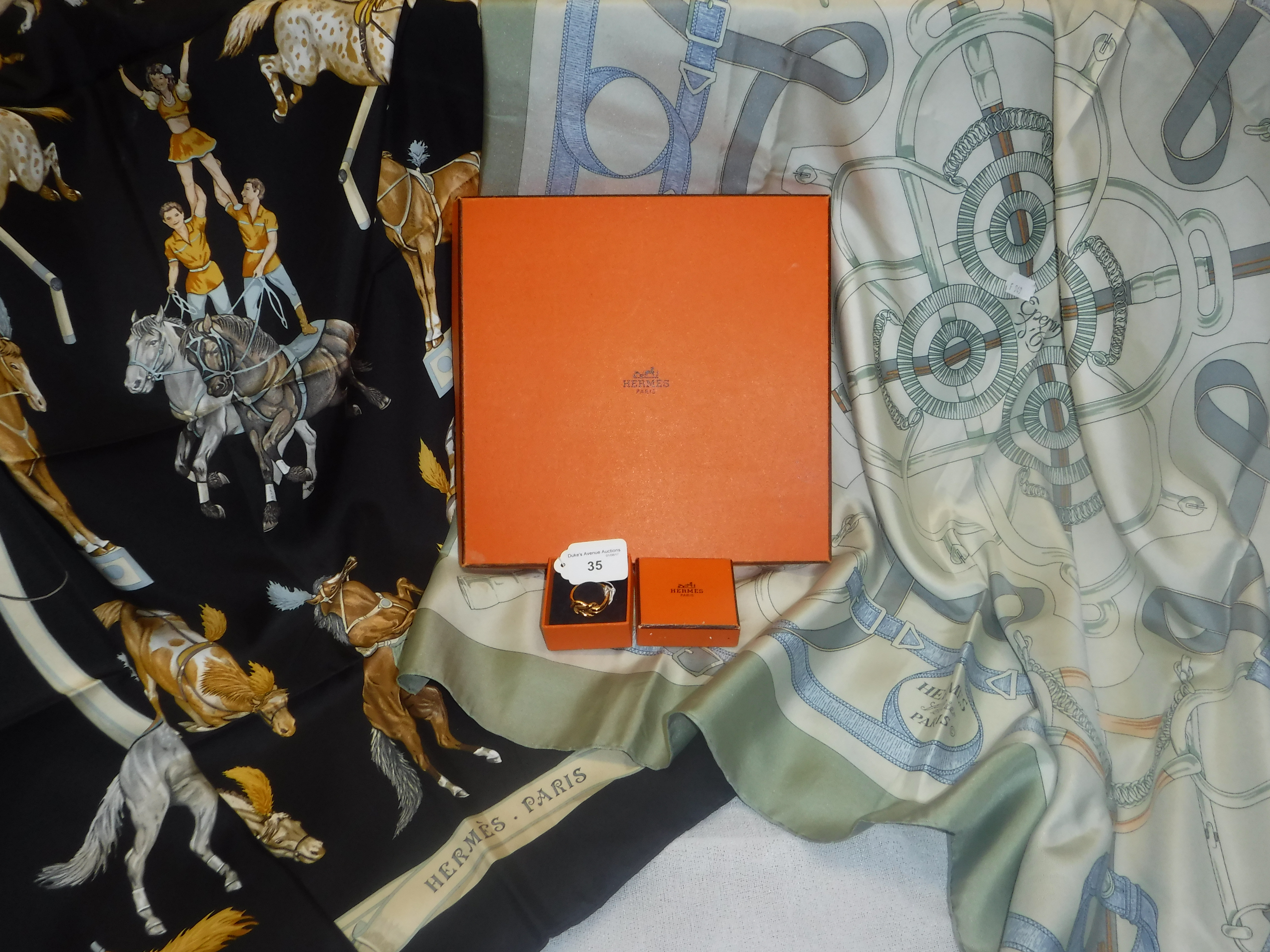 HERMES: TWO SILK SCARVES, 'Eperond'or' and another 'Enpiste', together with a boxed scarf ring,