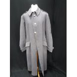 A GENTLEMAN'S VINTAGE LONG GREY/BLUE SINGLE BREASTED WOOLLEN OVERCOAT with silver Commemorative