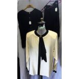'CHANEL BOUTIIQUE': A cream silk blouse with black edged detail to collar and two other similar