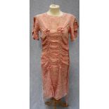 A 1940'S PATTERNED PINK ARTIFICIAL SILK DAY DRESS with rouched panel to the front with Utility '