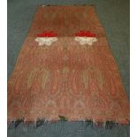 A LARGE INDIAN PAISLEY SHAWL fashioned in green, red and black, with central decoration, circa mid-