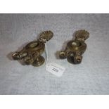 A PAIR OF BRASS OIL LAMPS with shell handles, 5" long