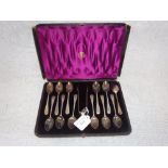 A SET OF TWELVE ENGRAVED SILVER TEASPOONS AND SUGAR TONGS, in a fitted 'R. Stewart, Glasgow',