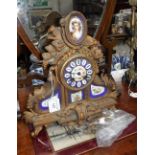 A 19TH CENTURY GILT SPELTER MANTEL CLOCK with inset porcelain panels, 12.5" high