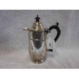 A SILVER WATER POT with ebony handle and finial, 8" high