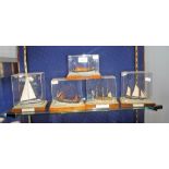 A SMALL SCALE MODEL OF HMS VICTORY and similar models each in perspex display boxes (5)