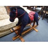 A CHILD'S SAFETY ROCKING HORSE, with a purple plush coat, made by 'Pegasus', 39" high x 49" long