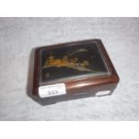 A JAPANESE HARDWOOD BOX with an inlaid metal top, decorated with buildings, signed, 5.25" wide