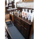 A DARK STAINED ERCOL SIDEBOARD and two Victorian chairs