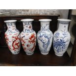 A PAIR OF ORIENTAL CERAMIC VASES, decorated with dragons and two similar (all drilled to the