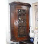 A GEORGE III MAHOGANY HANGING CORNER CABINET with glazed door 39" high