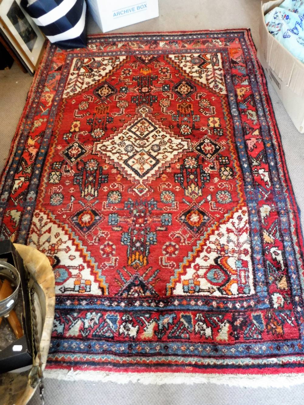 A RED GROUND PERSIAN RUG, 52" x 77"