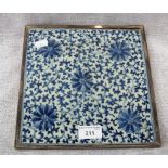 A CHINESE PORCELAIN TILE, decorated in blue with floral decoration in a silver plated stand mount,