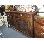 A LATE VICTORIAN CARVED OAK SIDEBOARD 61" wide