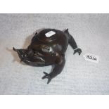 AN ORIENTAL BRONZE INKWELL in the form of a Grotesque three-legged toad, 4" high