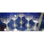 A SET OF FOUR VICTORIAN CHAMPAGNE GLASSES with hollow slice-cut stems and one other similar (5)