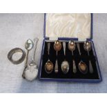 A QUEEN ELIZABETH II NAPKIN RING and a set of six silver coffee spoons, in a fitted presentation