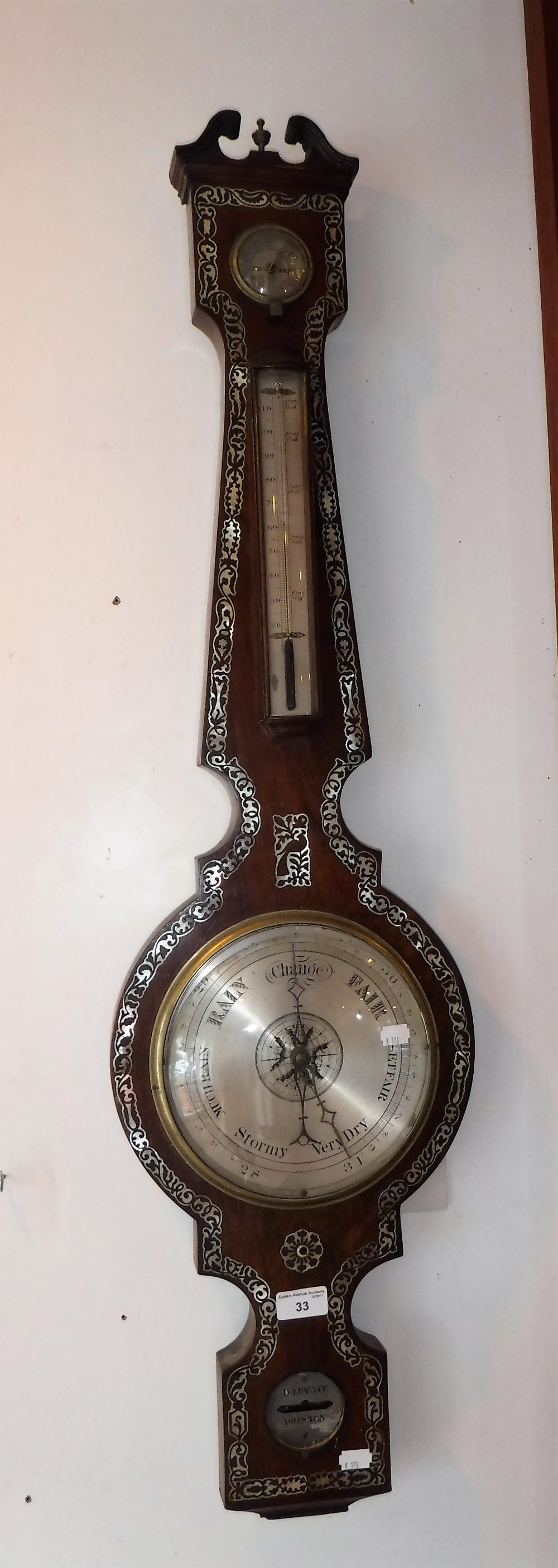 A REGENCY ROSEWOOD WHEEL BAROMETER with mother-of-pearl inlay decoration and signed 'D. Luvate,