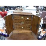 A VICTORIAN WALNUT TABLE CABINET with inlaid decoration , fitted three interior drawers behind a