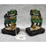 TWO SIMILAR MINIATURE CHINESE LION DOGS on hardwood bases