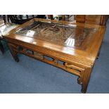 A CHINESE ELM LOW TABLE of traditional design with carved and fretted top, covered by a glass plate,