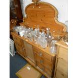 A VICTORIAN STRIPPED PINE SIDEBOARD with glass knobs and shaped superstructure, 52" wide