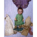 A 1930S CERAMIC HEADED DOLL stamped 'A. M.' and a collection of period clothes