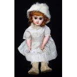 AN EARLY 20TH CENTURY FRENCH PORCELAIN HEADED DOLL, she is dressed in period clothes with a white