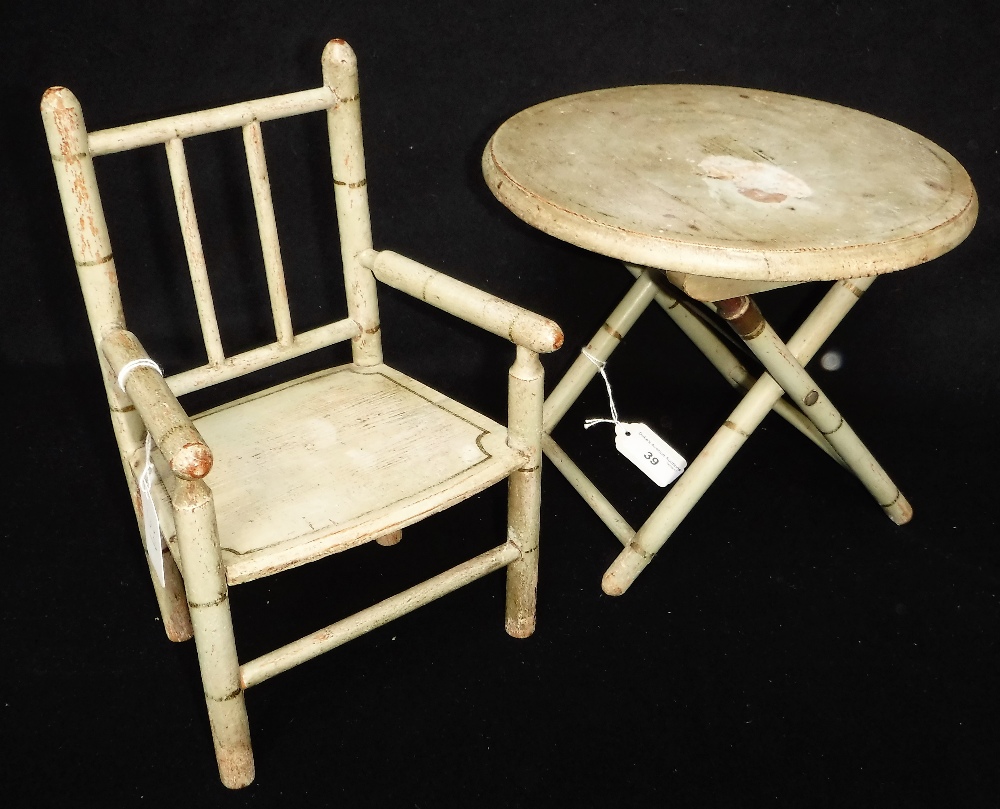 AN EDWARDIAN DOLL'S FOLDING TABLE, with original green and gilt paint work 8" high and a matching