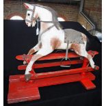 AN EARLY 20TH CENTURY 'SAFETY' ROCKING HORSE of small proportions, with what appears to be the