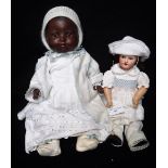 AN EARLY 20TH CENTURY 'LIMOGES' PORCELAIN HEADED DOLL, 12" high and an 'A M' black doll with