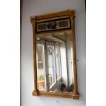 A SMALL REGENCY PIER GLASS in a gilt frame, with painted glass panel decorated with a drum, red