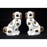 A PAIR OF STAFFORDSHIRE DOGS with gilt lustre decoration, 9" high