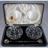 A CASED SET OF GLASS SUGAR BOWLS with silver spoons