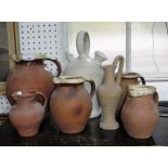 A SET OF FOUR DEVON POTTERY GRADUATED TERRACOTTA JUGS and a 'Lakes Cornish Pottery' jug and other