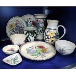 A COLLECTION OF POOLE POTTERY including traditionally decorated vases and plates