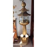 A PAIR OF ORIENTAL BRASS PAGODA LANTERNS, each on an octagonal base supporting a lotus flower