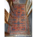 A RED GROUND PERSIAN RUG, 40" X 70"