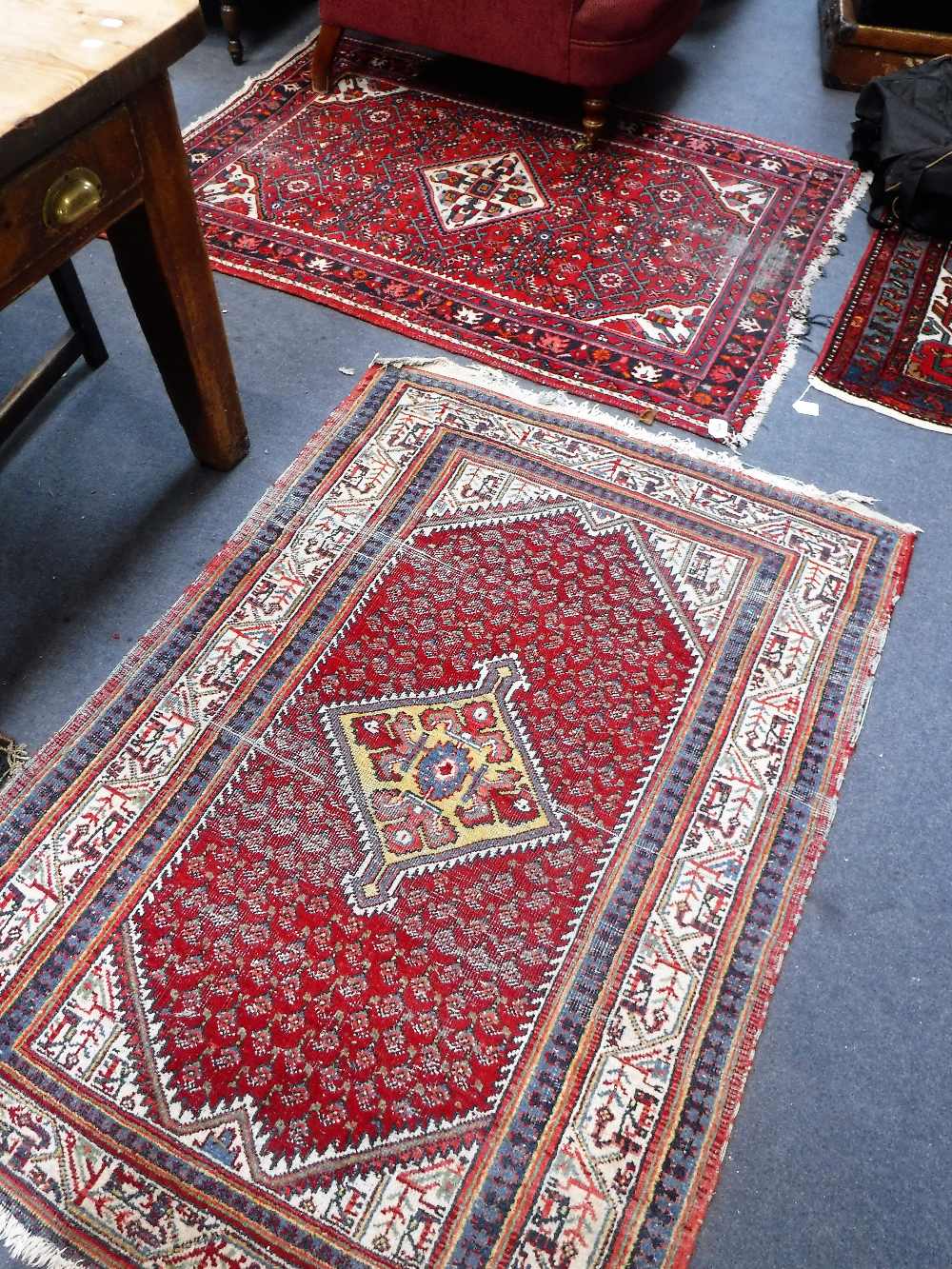 A RED GROUND PERSIAN RUG, 42" X 60" and another 44" x 62"