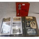 AN EDWARDIAN POSTCARD ALBUM containing many Edwardian and later cards and two similar albums