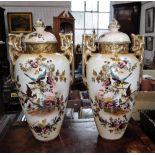 A LARGE PAIR OF VICTORIAN TWIN HANDLED VASES AND COVER decorated with gilt highlights, flowers and