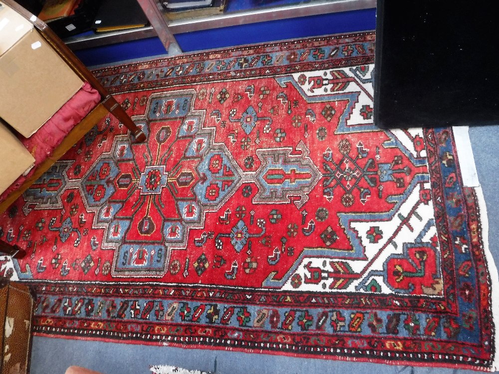 A RED GROUND PERSIAN RUG, 42.5" X 78"