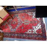 A RED GROUND PERSIAN RUG, 42.5" X 78"