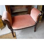 A LATE 19TH CENTURY MAHOGANY DRESSING STOOL with scrolling arms and carved decoration