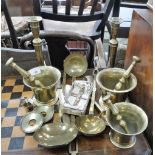 TWO 19TH CENTURY BRASS PESTLE AND MORTARS and a pair of brass tapered candlesticks and other