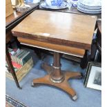 A REGENCY ROSEWOOD GAMES TABLE, the revolving fold-over top with inlaid chess board, on a platform