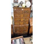 A REPRODUCTION MAHOGANY SERPENTINE FRONTED CHEST ON CHEST with brushing slide, of small proportions,