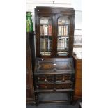 A 1920S OAK 'JACOBETHAN' BUREAU BOOKCASE, 31" wide