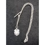 A SILVER WATCH CHAIN with pierced and engraved fob